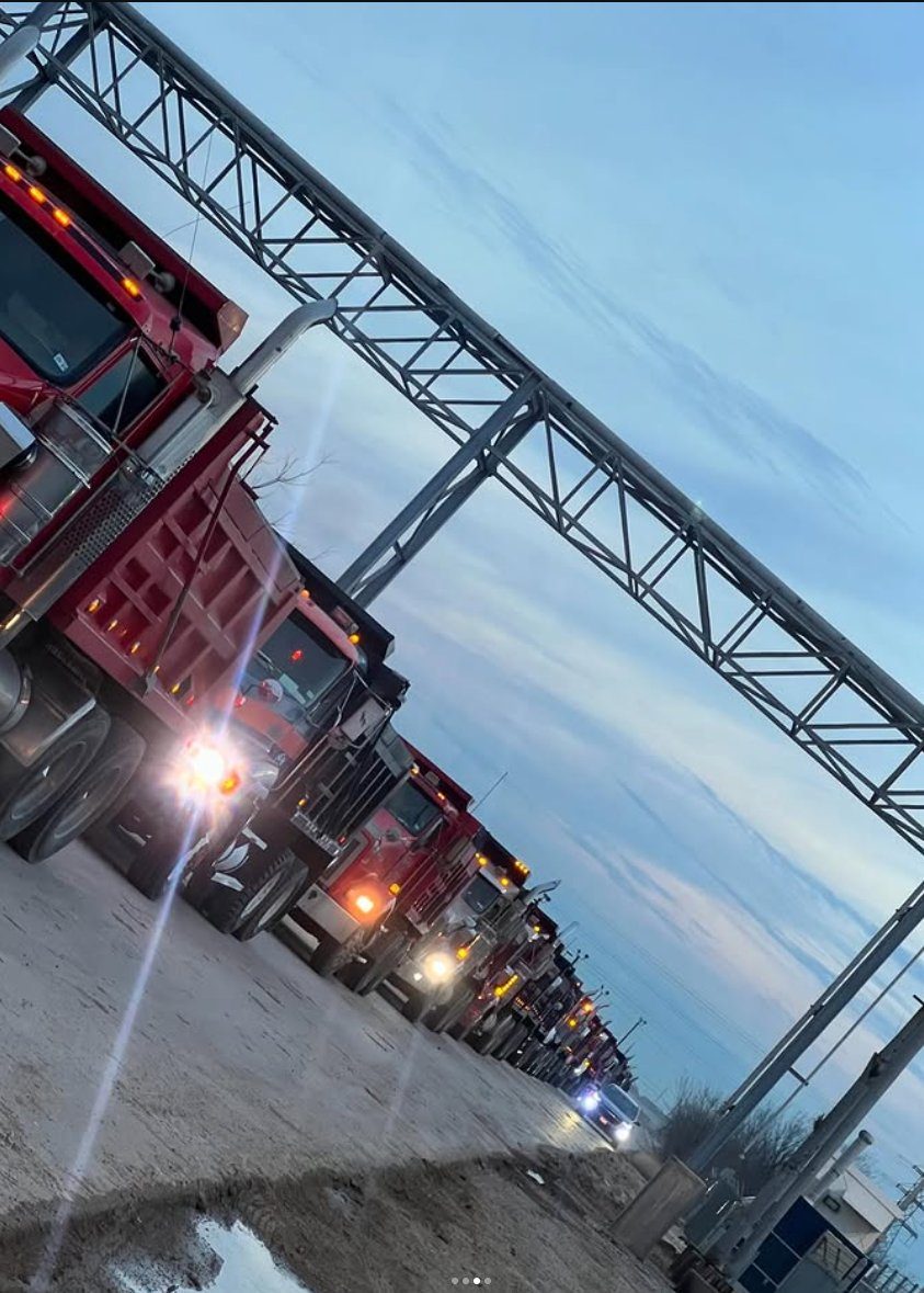 Supreme Logistics dump truck fleet staged for an early-morning mobilization in the Houston area