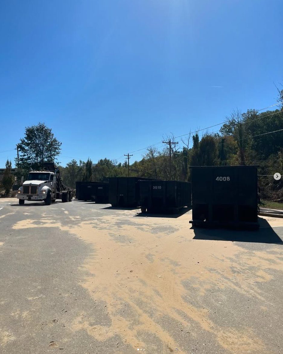 Supreme Logistics roll-off truck delivering roll-off dumpsters for jobsite debris haul-off